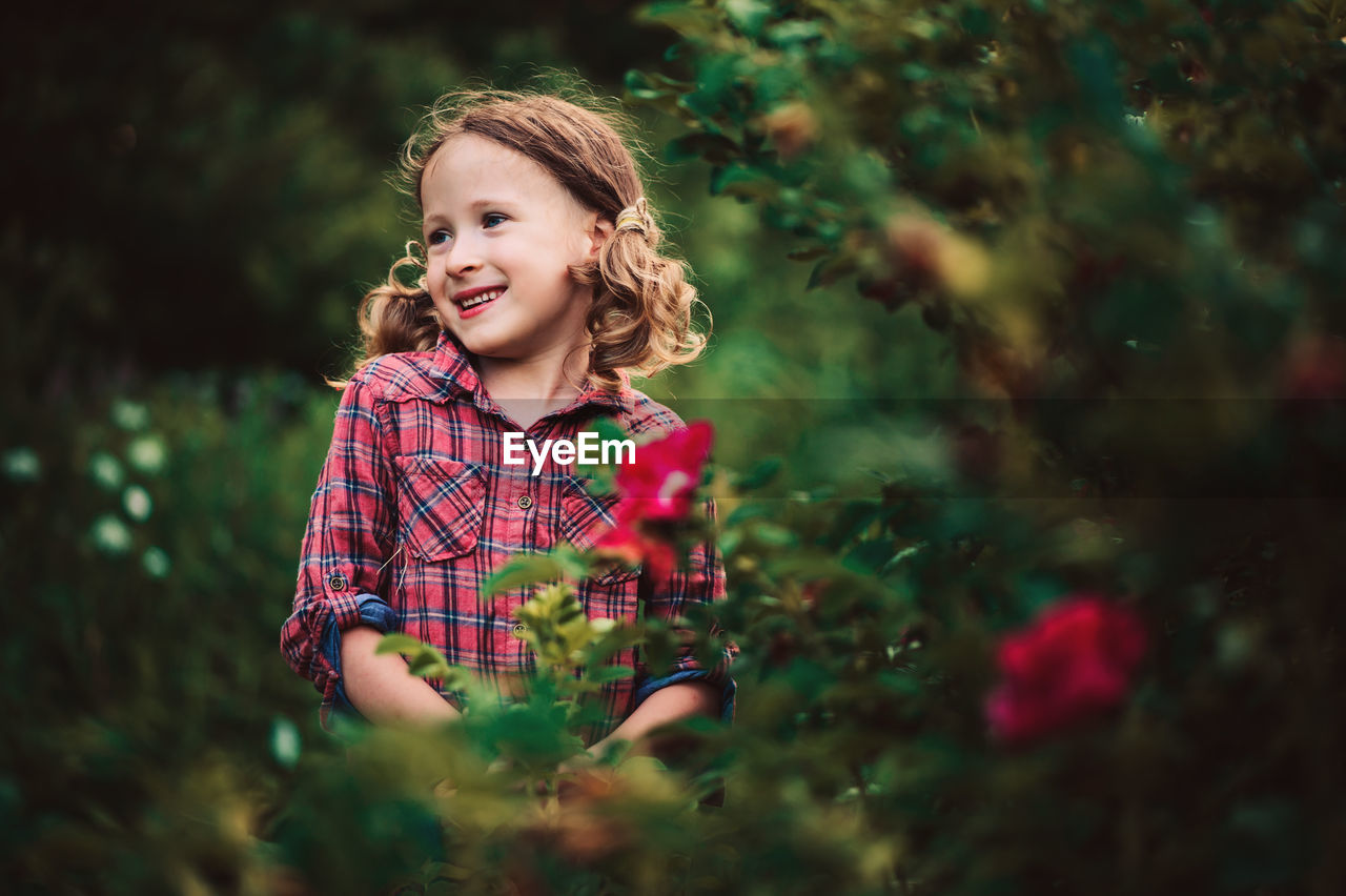 Close-up of cute girl looking away while standing at park