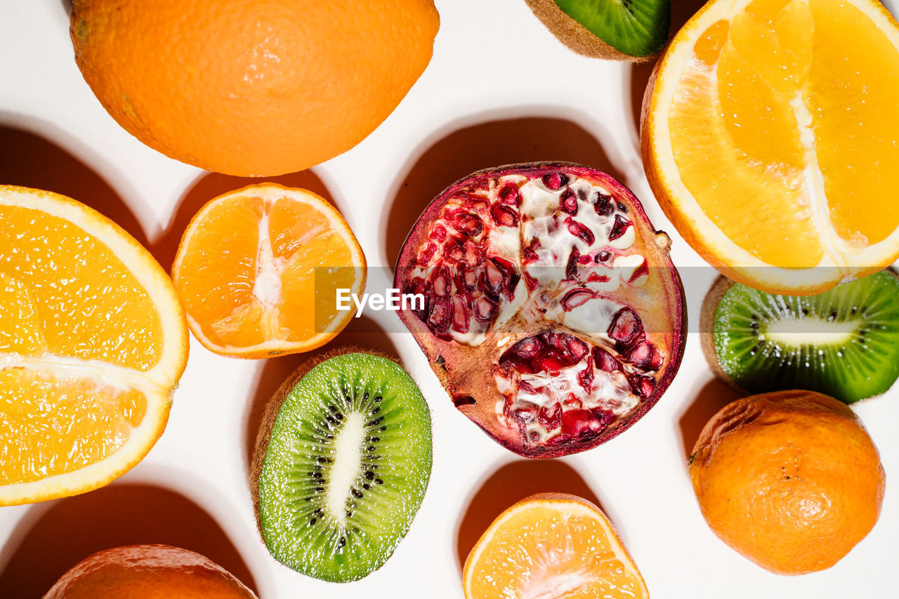 High angle view of sliced lemons and kiwi on table