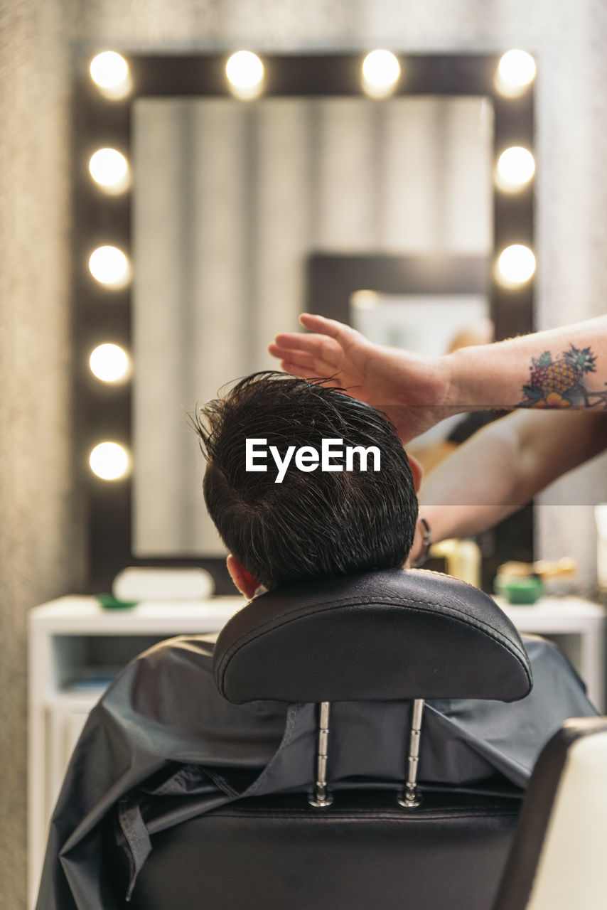 Rear view of man in barber shop