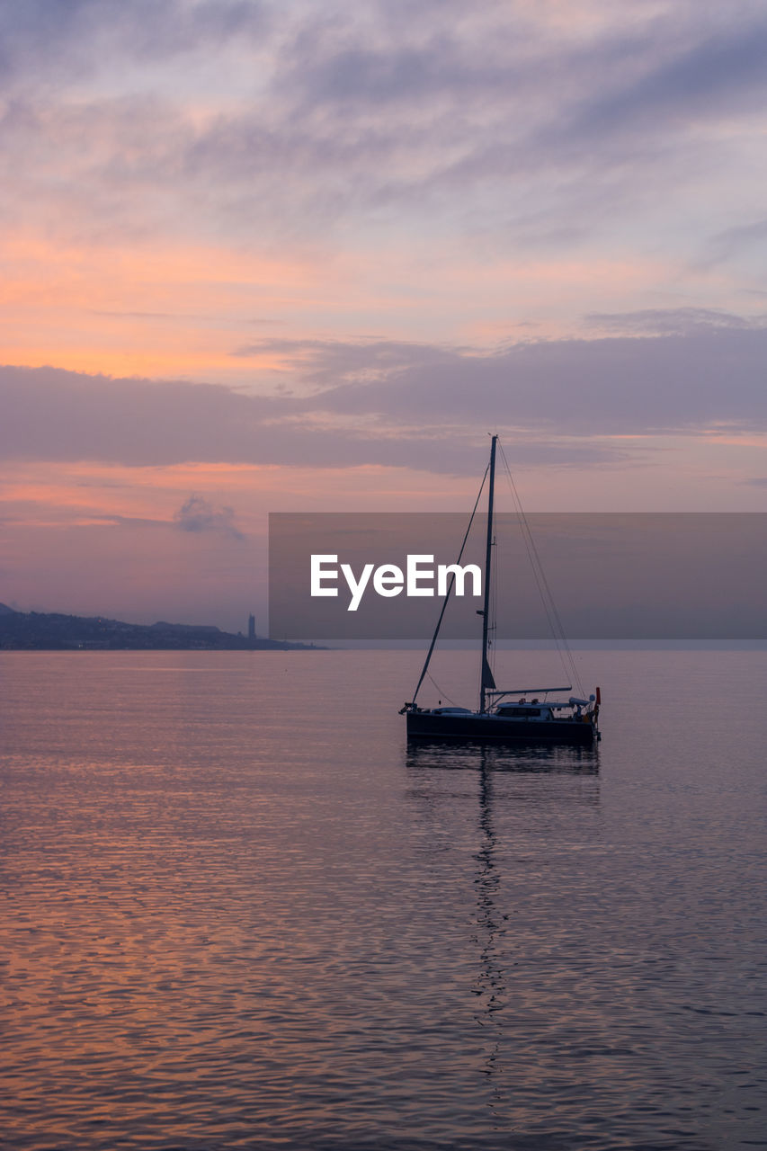 SAILBOAT ON SEA AGAINST SKY DURING SUNSET