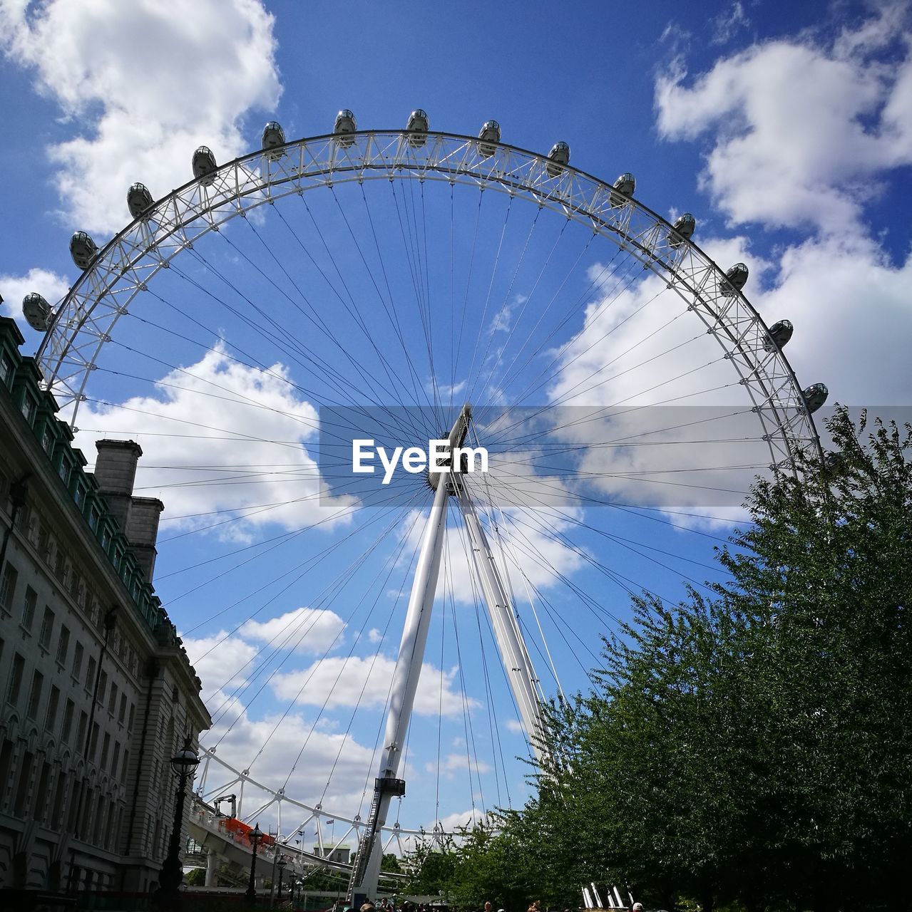 LOW ANGLE VIEW OF FERRIS WHEEL IN SKY