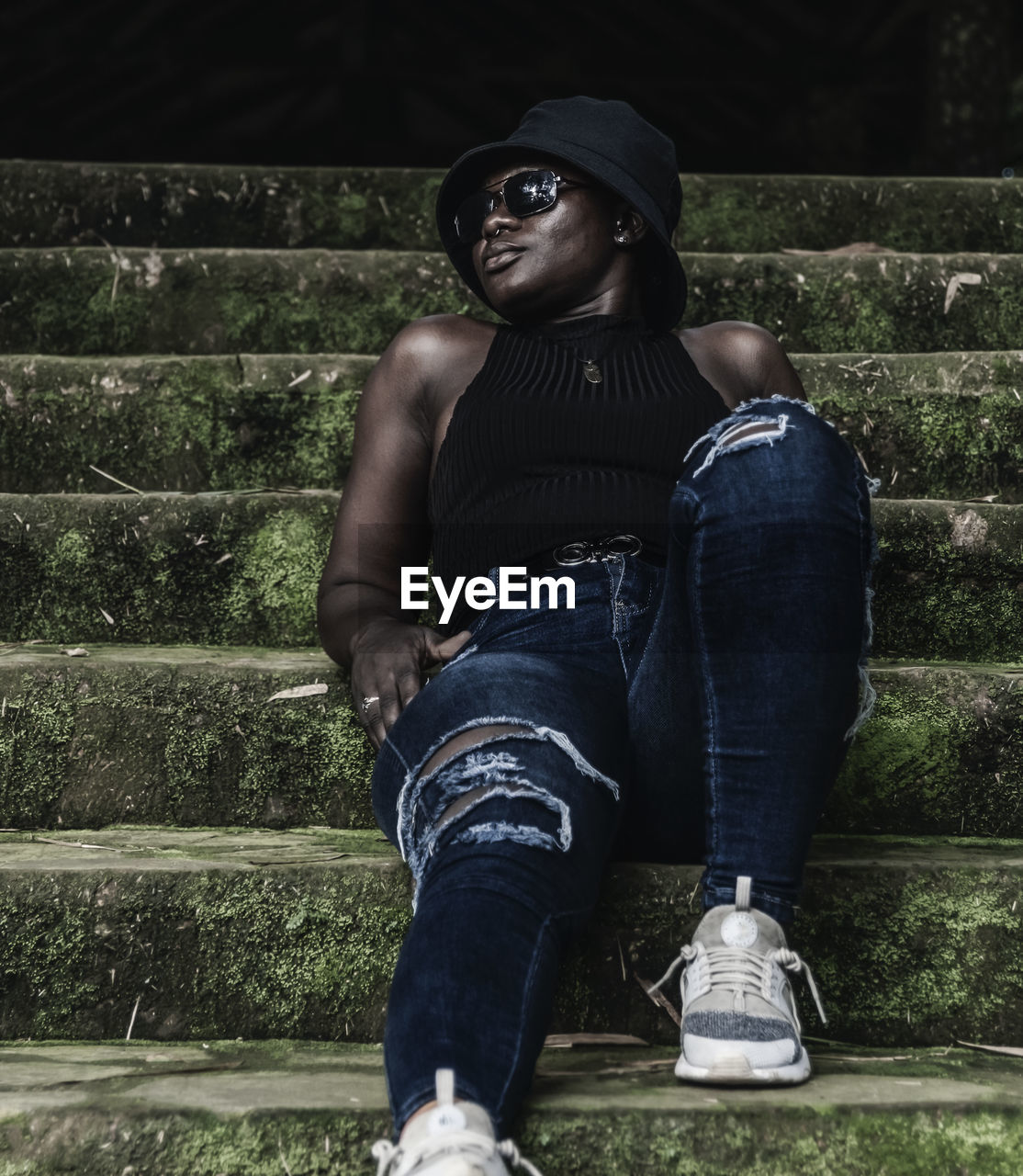 one person, black, casual clothing, adult, architecture, staircase, young adult, lifestyles, clothing, leisure activity, fashion, full length, person, jeans, sitting, portrait, outdoors, looking, hat, men, day, standing, nature, relaxation, footwear, spring, photo shoot