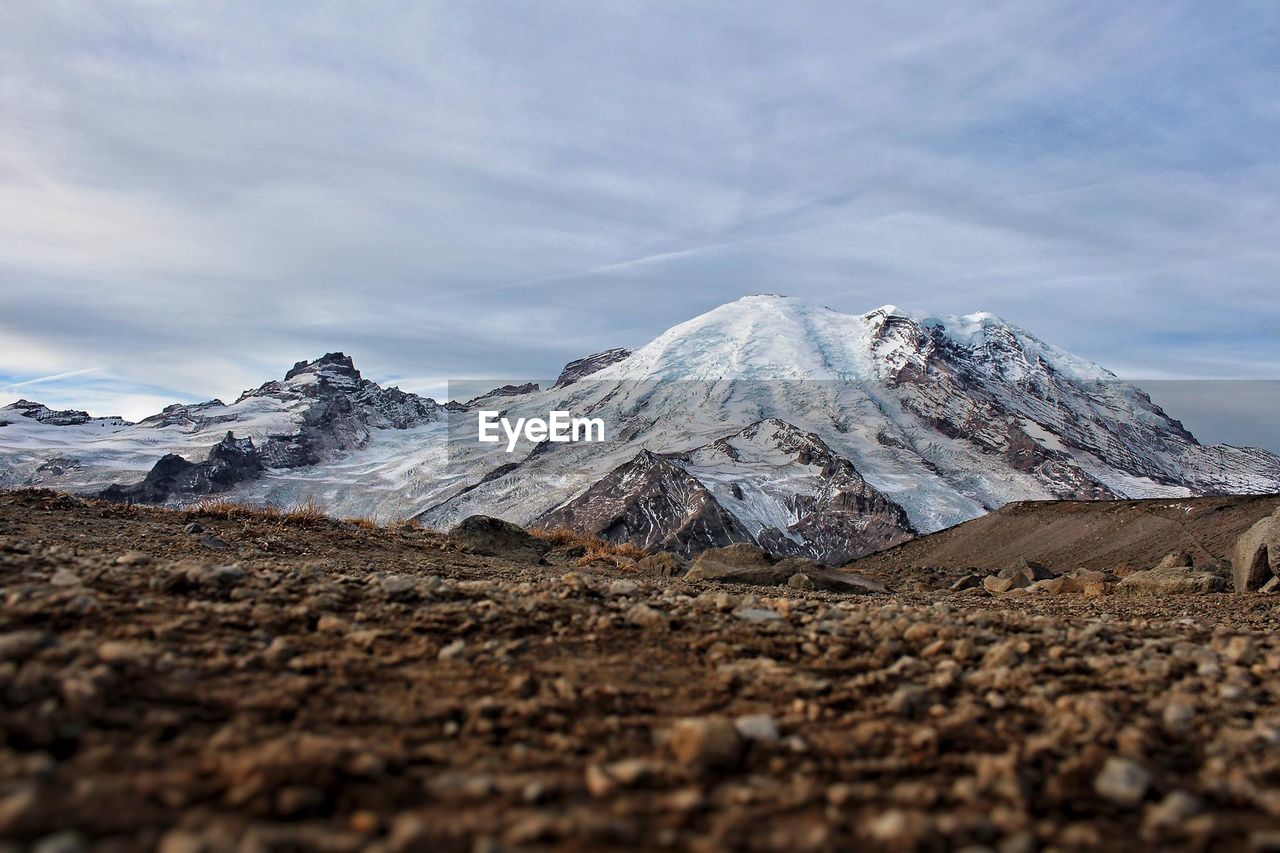 Low angle view of mountains against cloudy sky