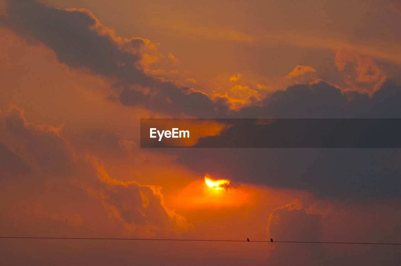 Low angle view of dramatic sky during sunset