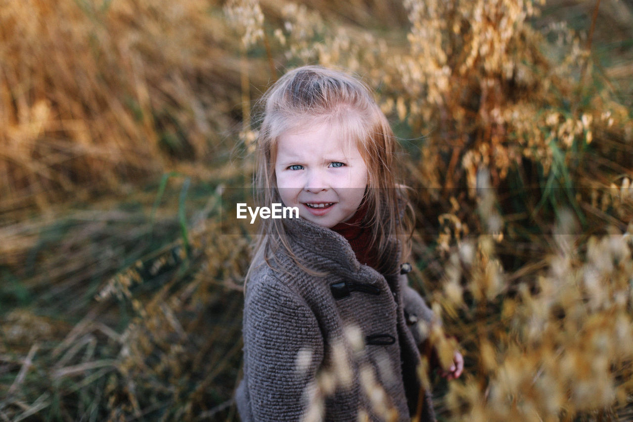 Portrait of smiling girl standing outdoors