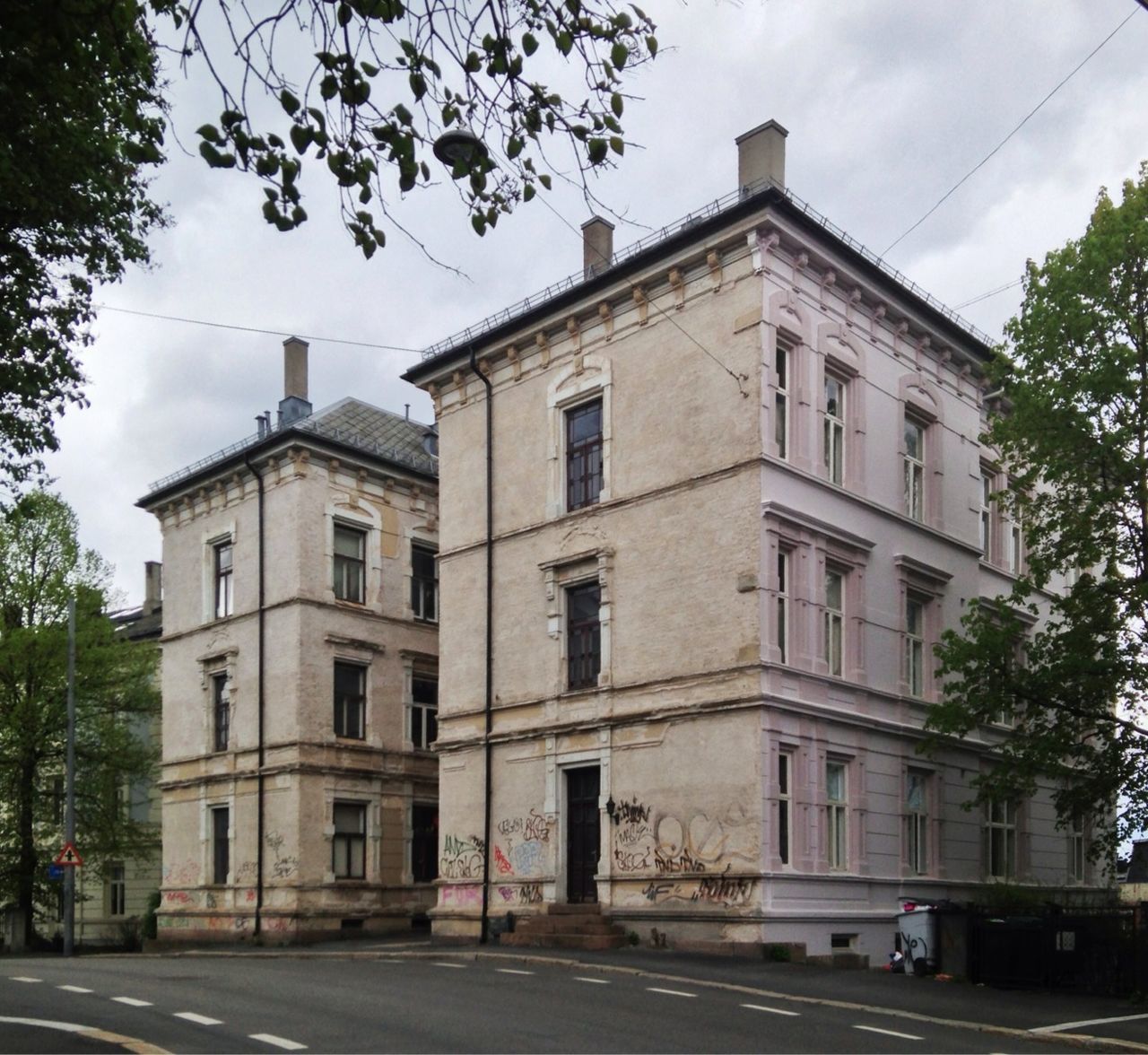 Empty road against buildings