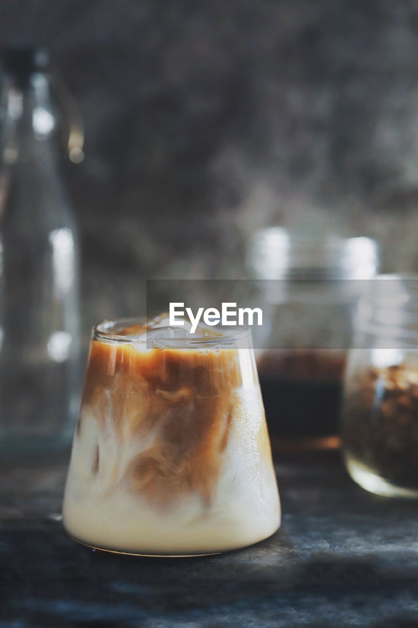 Ice latte with ice cube and espresso shot.texture of ice latte over dark background.