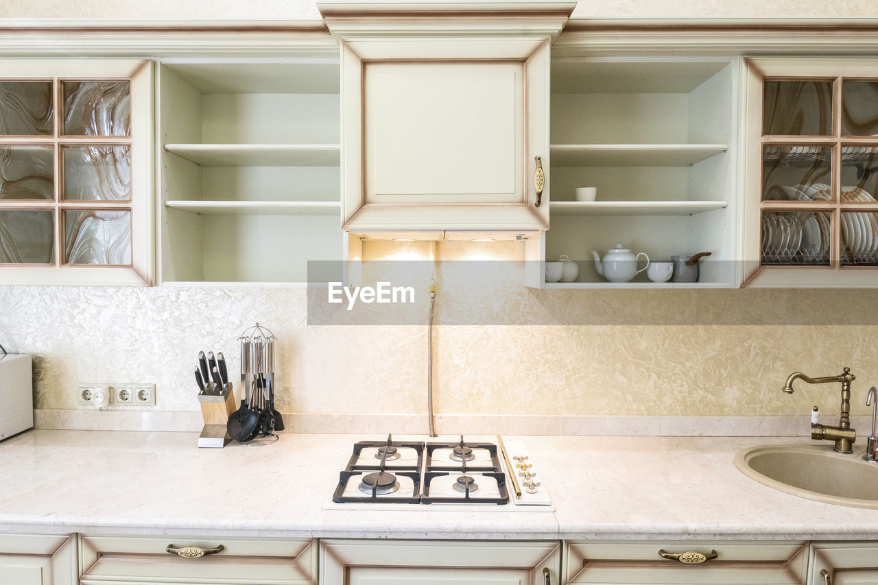 White kitchen set in the house with large dining room.