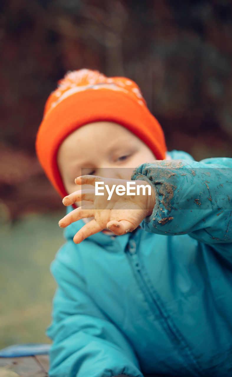 Portrait of little boy playing outdoors during winter