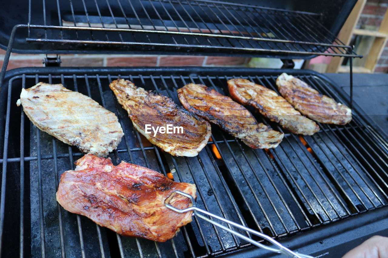 food, grilling, barbecue, food and drink, barbecue grill, grilled, meat, freshness, cooking, outdoor grill, heat, dish, cuisine, roasting, fast food, no people, metal, high angle view, fish, meal, preparing food, outdoors, day, coal, grid, kitchen appliance, burning, close-up, metal grate, grate, healthy eating, smoke, wellbeing, red meat, fire