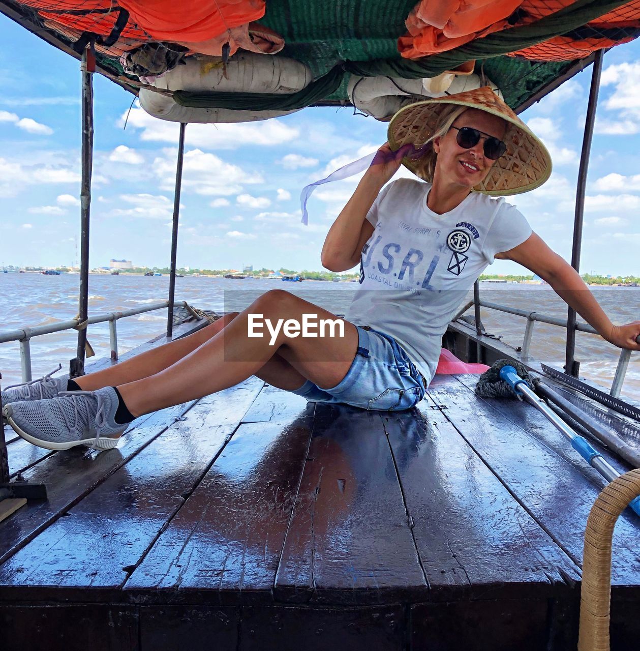 Woman sitting in boat on river