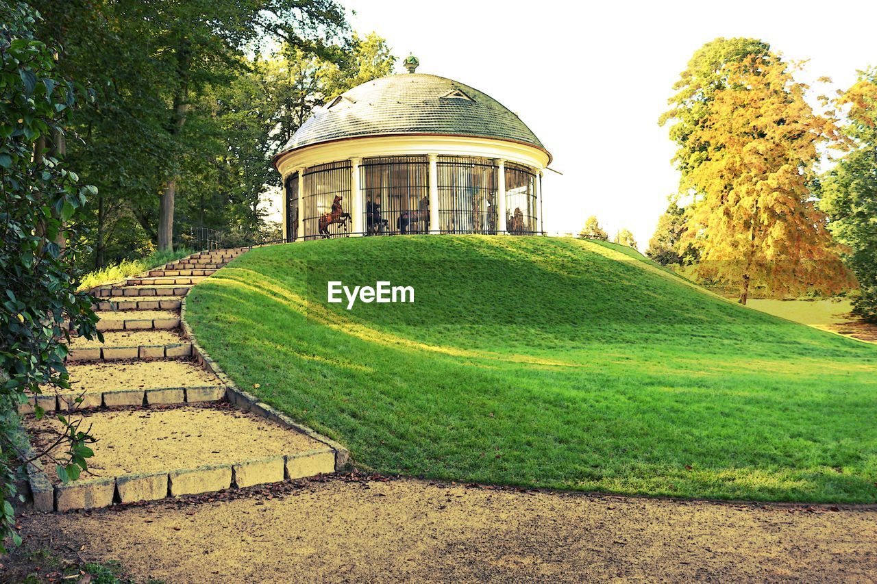 Low angle view of dome on field against sky