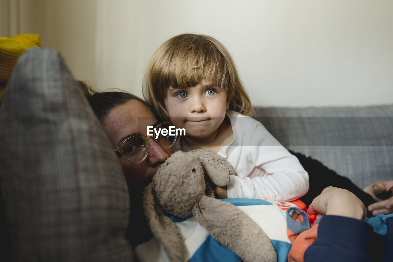 Mother with daughter on sofa