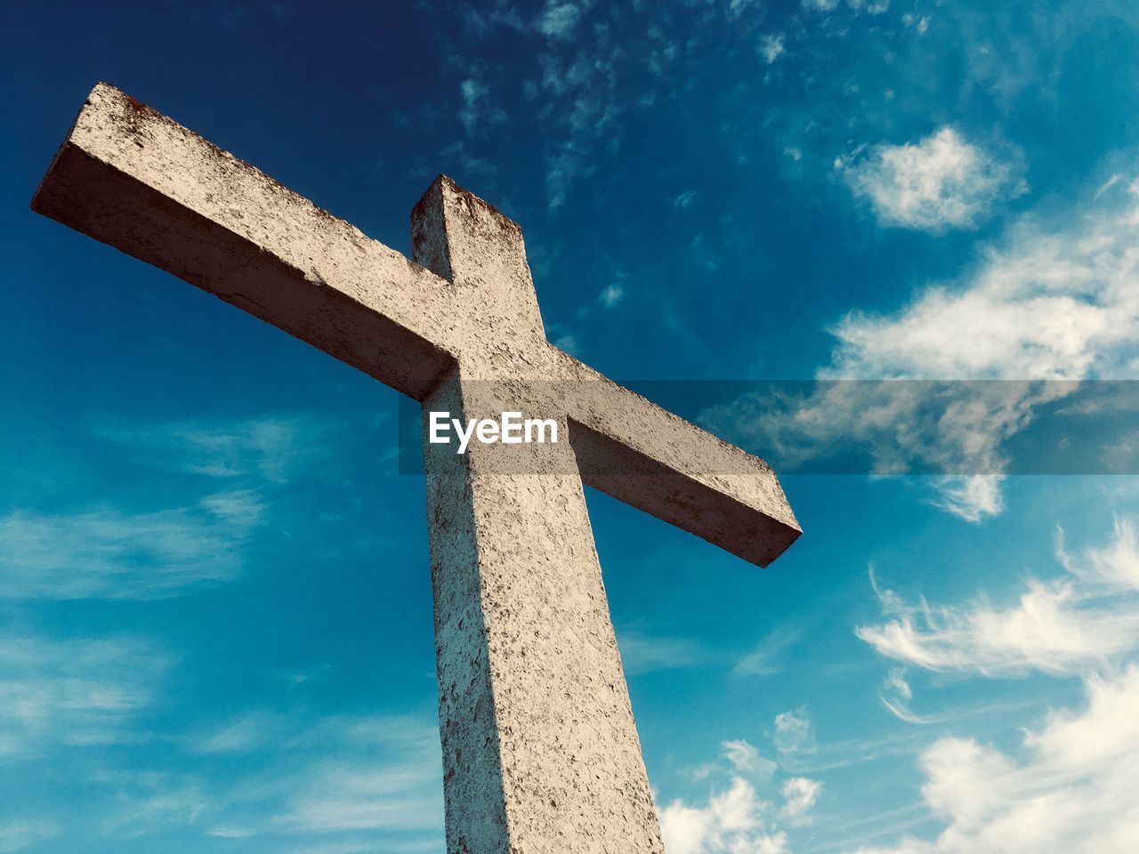 Low angle view of cross against blue sky