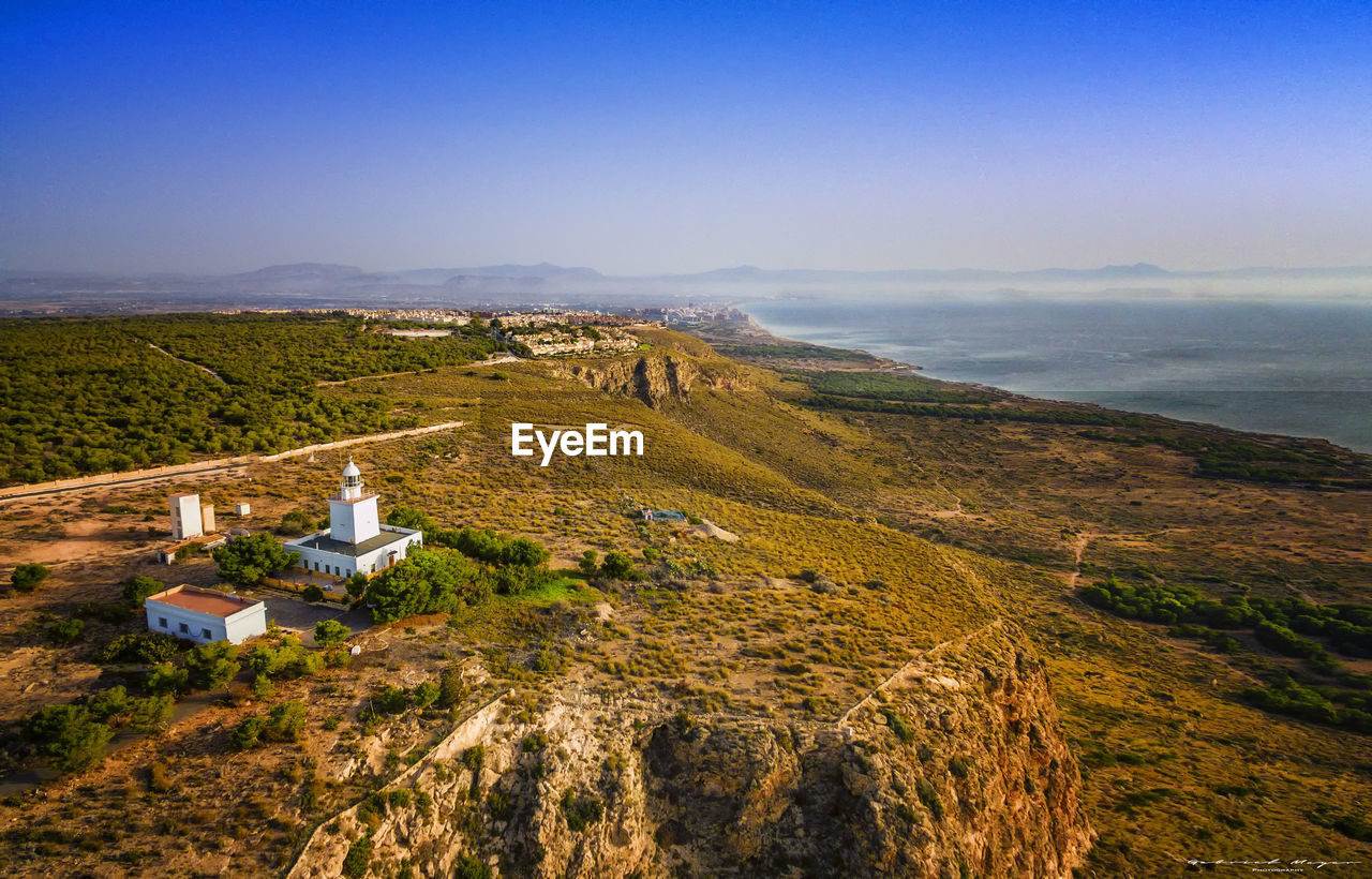 High angle view of land and sea against sky