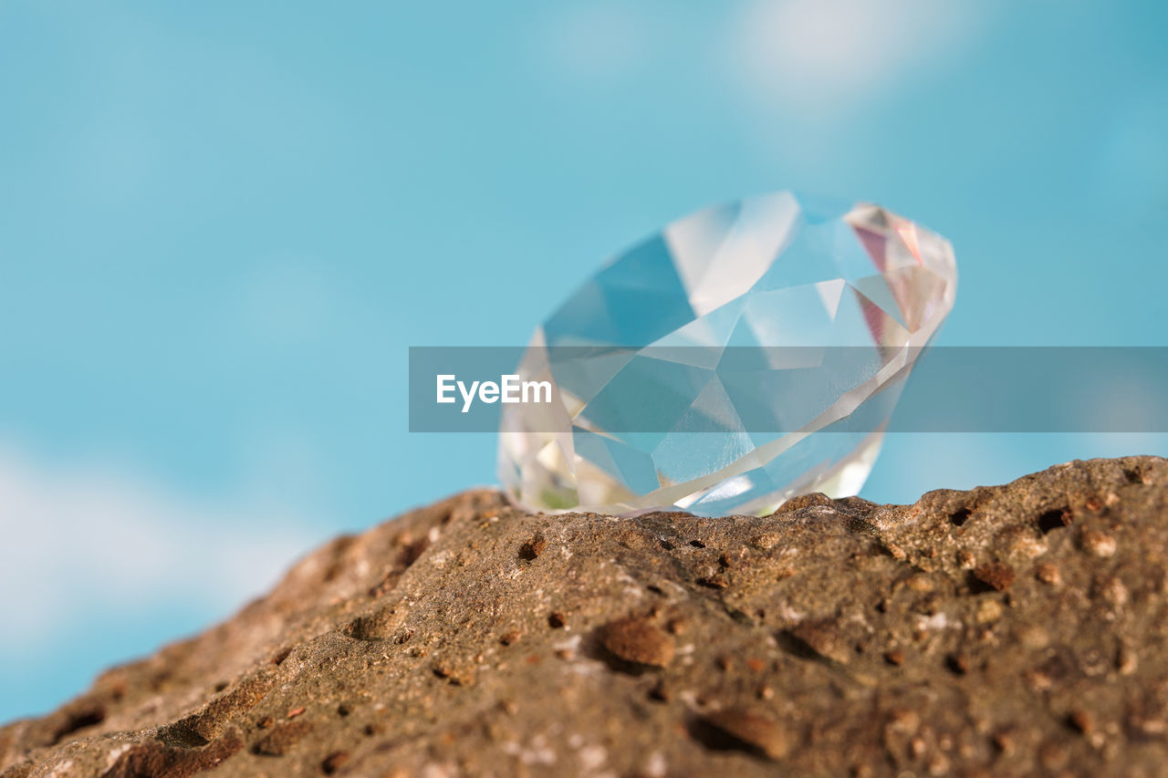 blue, jewelry, nature, no people, rock, gemstone, close-up, wealth, diamond, macro photography, outdoors, luxury, shiny, copy space, day, selective focus