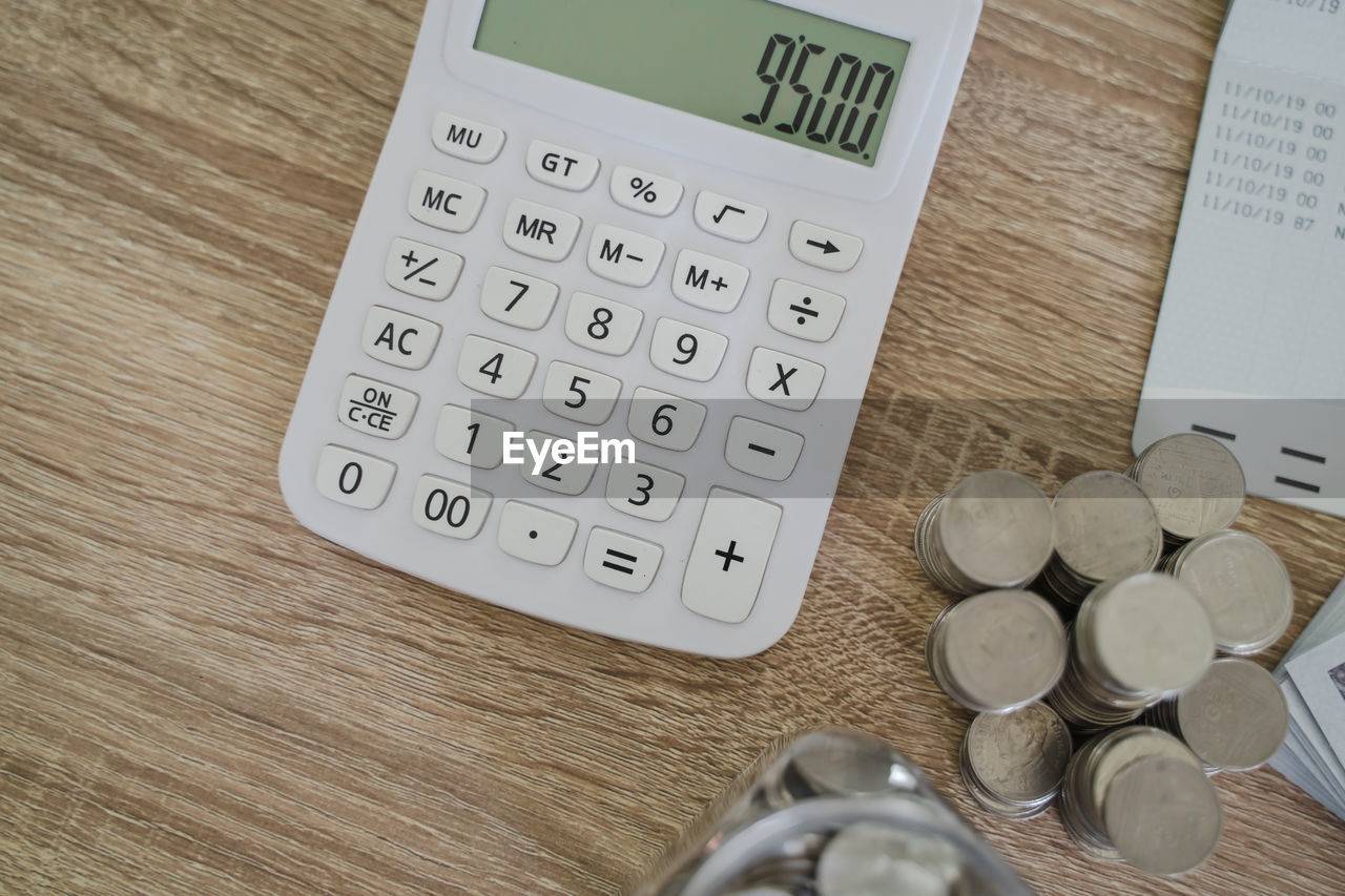 calculator, finance, cash, business, indoors, number, table, money, office equipment, finance and economy, technology, no people, wood, currency, high angle view, business finance and industry, savings, coin