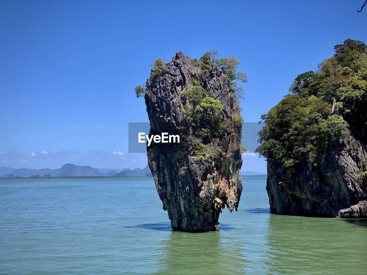 Scenic view of rock formation in sea against sky