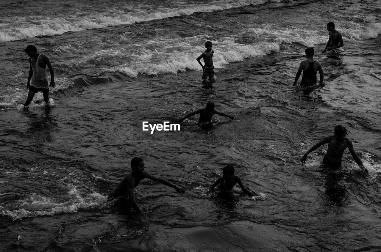 High angle view of people enjoying in sea