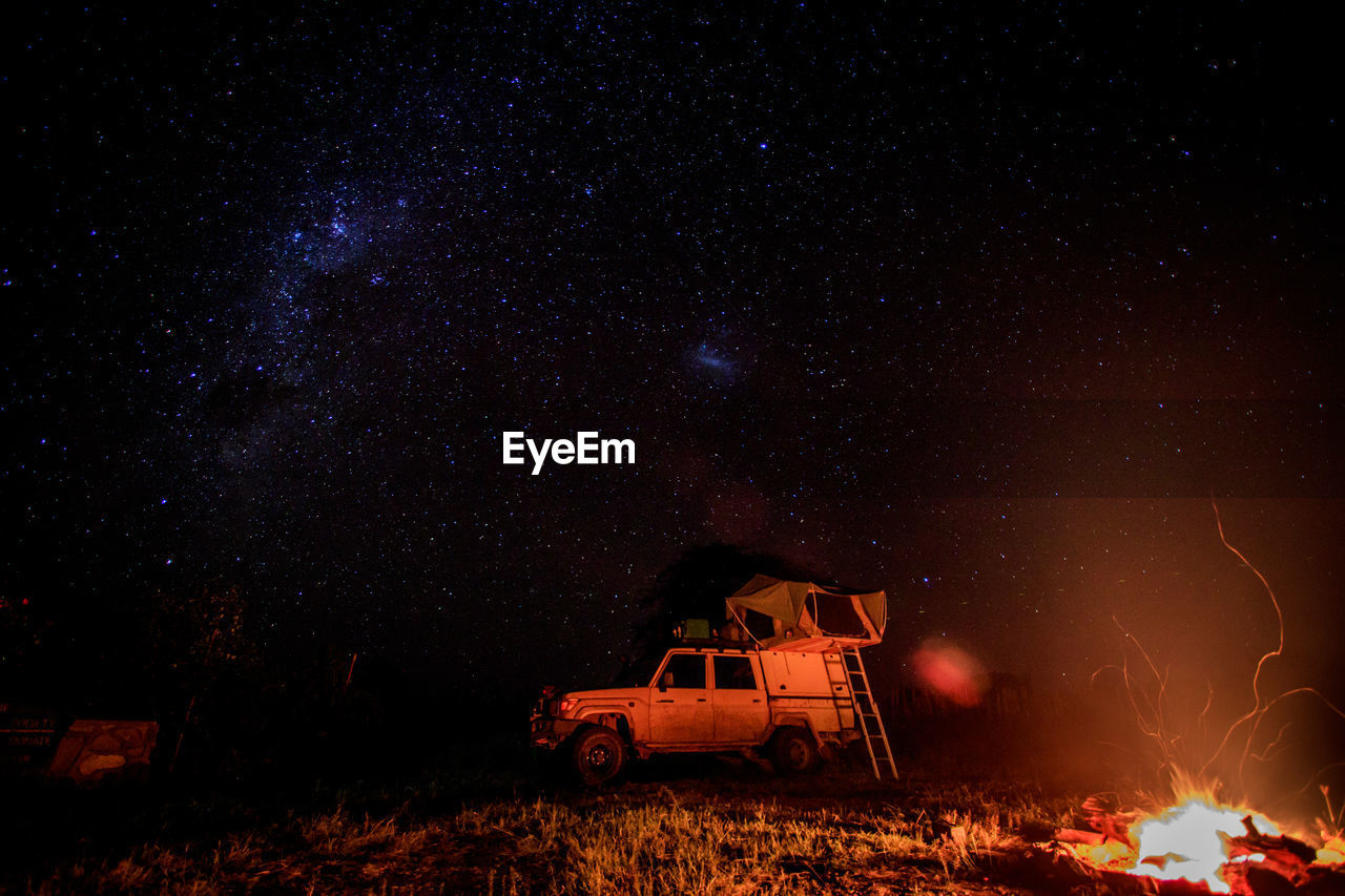 Vehicle and bonfire at night