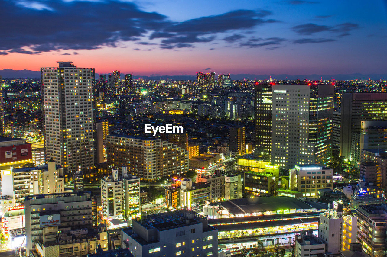 High angle view of illuminated buildings in city at night