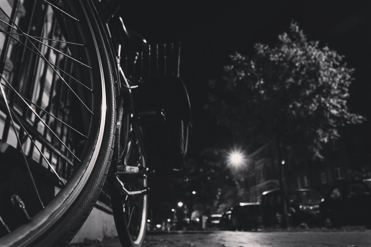 Low angle view of bicycle on illuminated road at night