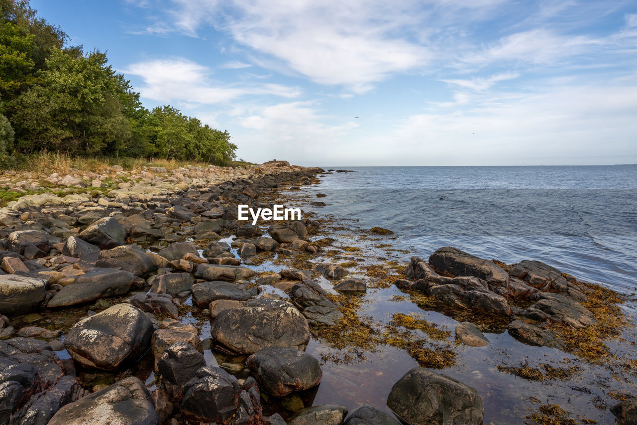 SCENIC VIEW OF ROCKS IN SEA AGAINST SKY
