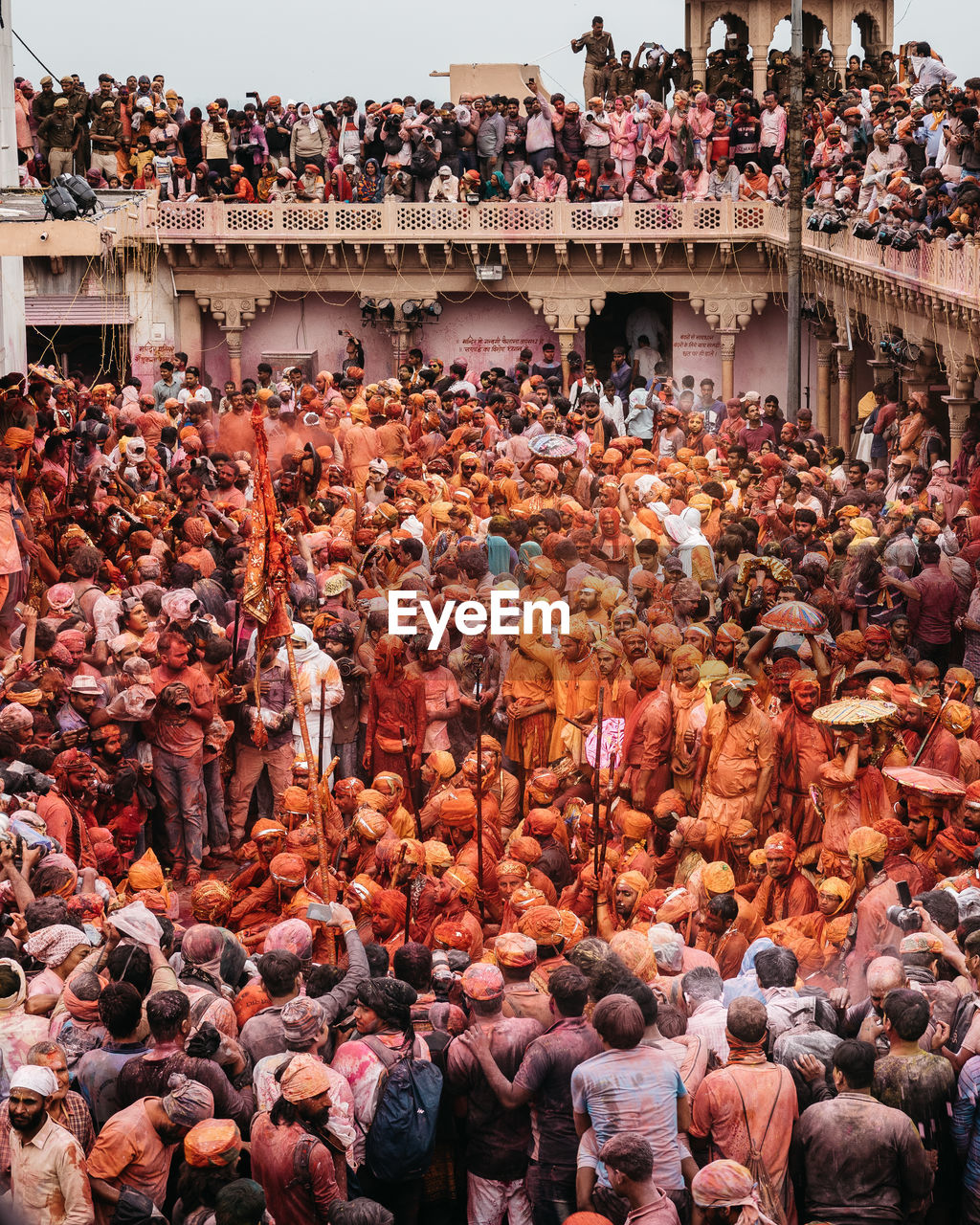 HIGH ANGLE VIEW OF GROUP OF PEOPLE IN FRONT OF BUILT STRUCTURES