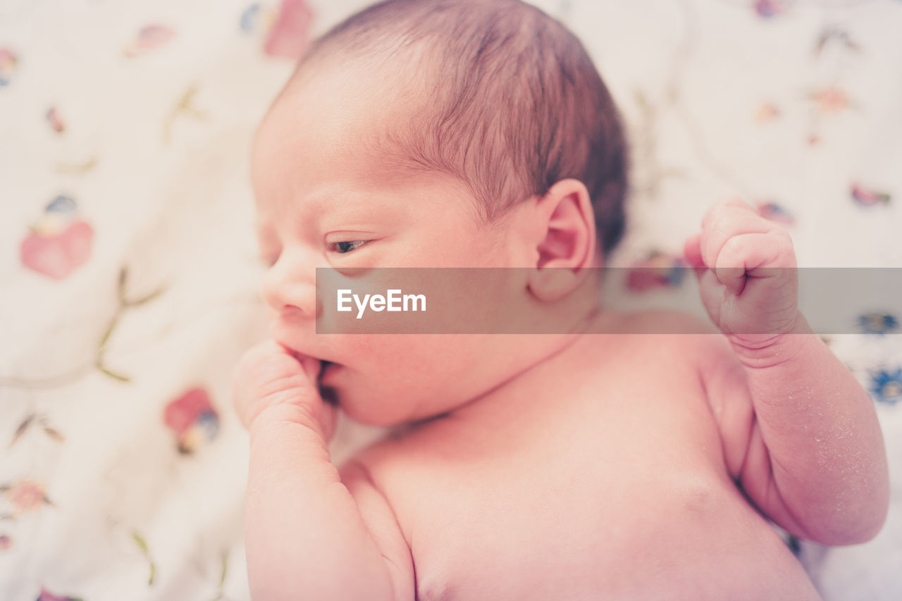 Close-up of cute baby girl at home