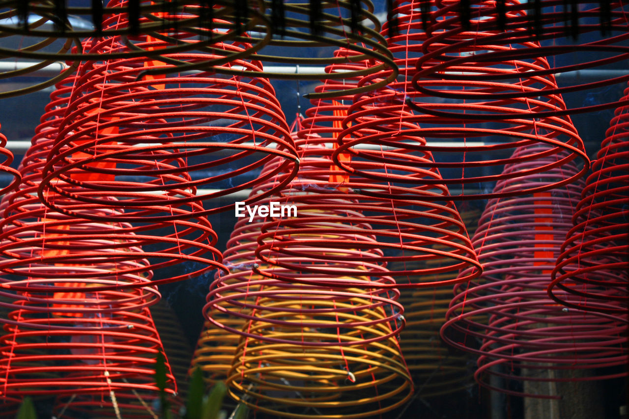 Close-up of spiral shaped incenses in temple