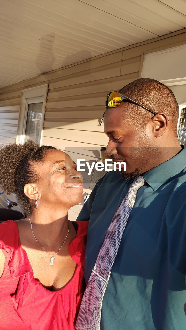 Smiling couple standing at home