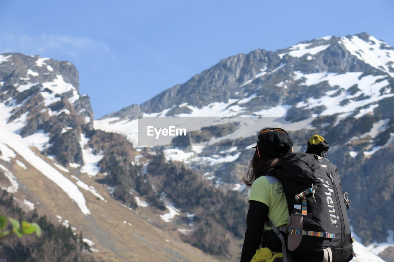 TOURISTS ON MOUNTAIN PEAK