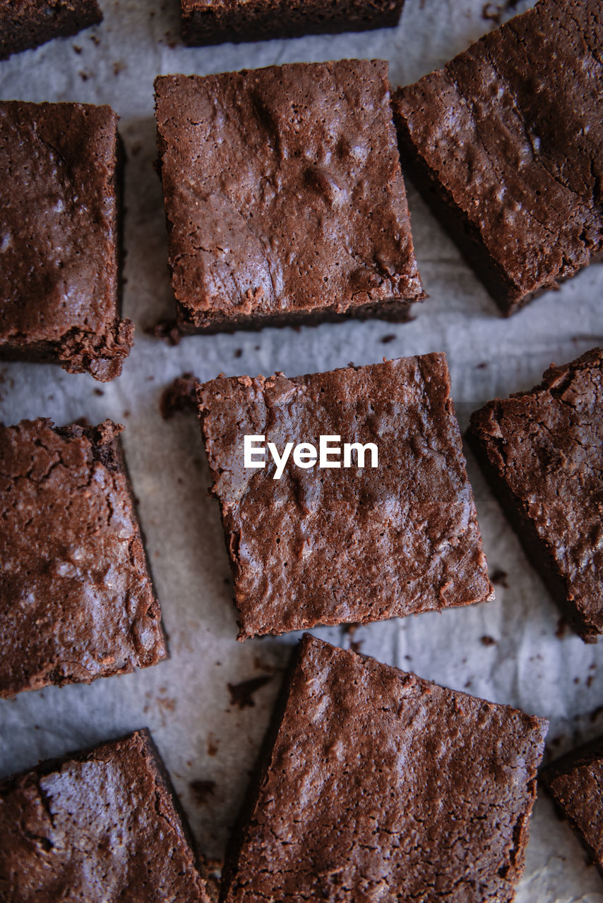 Top view of tasty soft brownie pieces on parchment