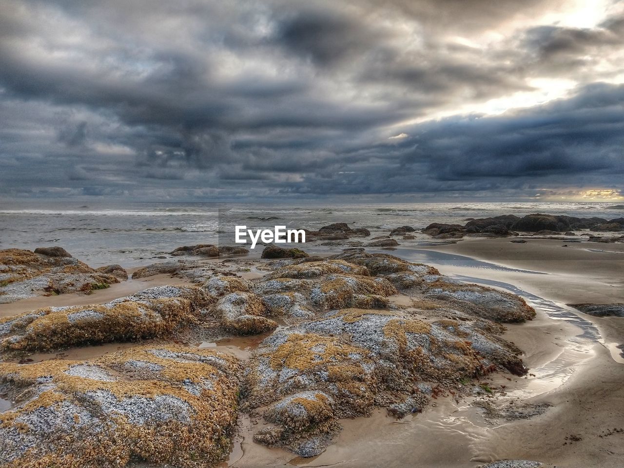 Scenic view of sea against cloudy sky