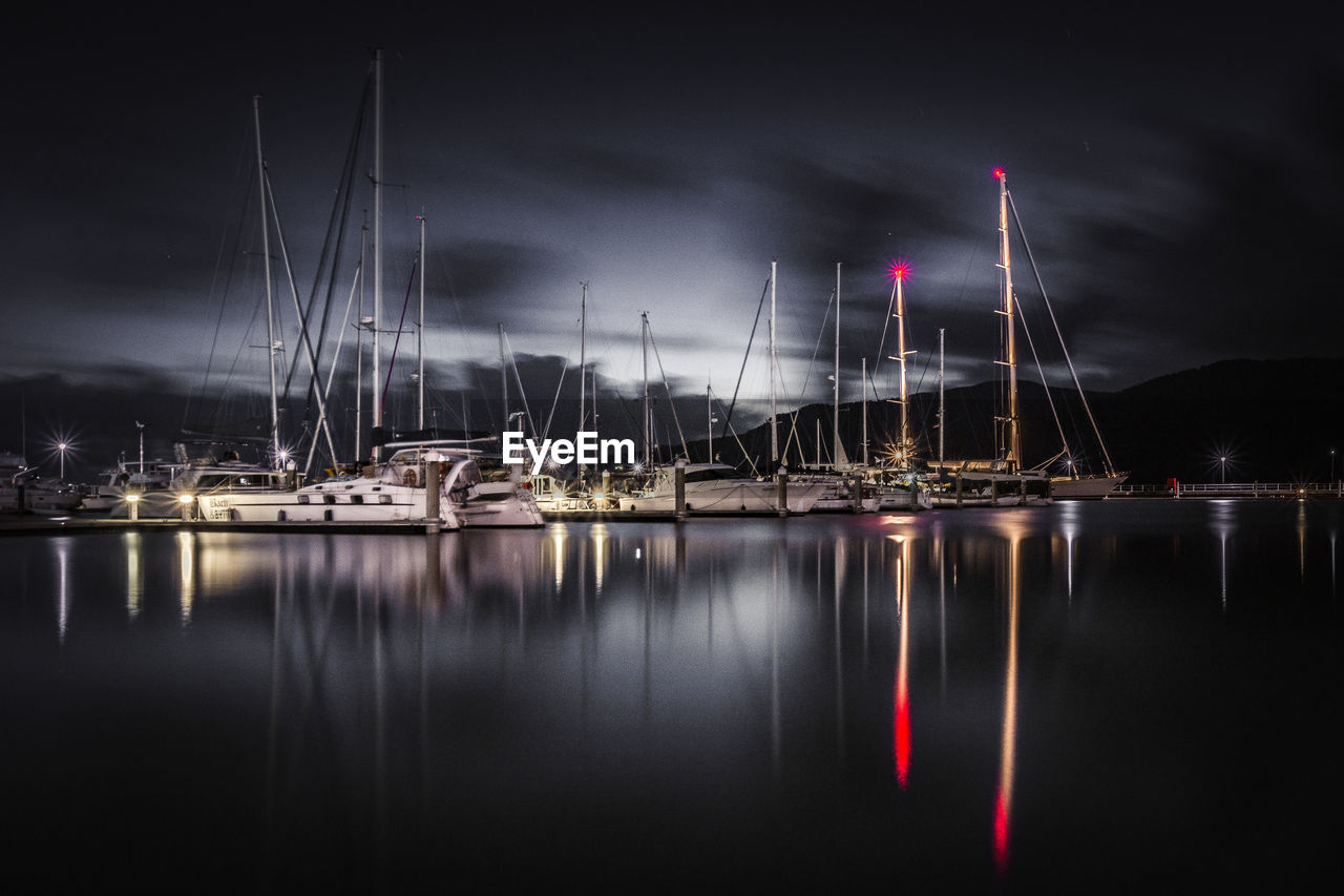 Reflection of illuminated boats in water