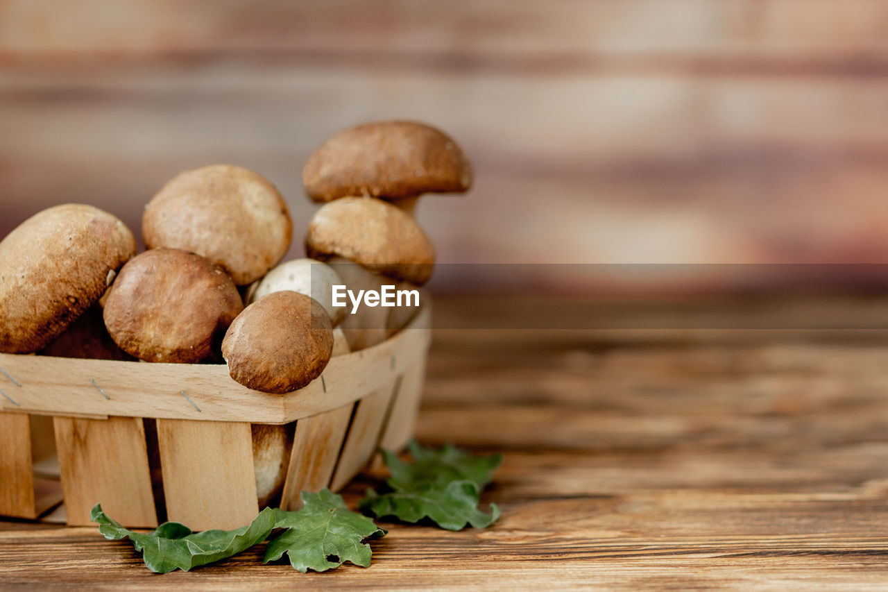 food, food and drink, freshness, wood, healthy eating, produce, vegetable, wellbeing, no people, table, still life, indoors, mushroom, close-up, organic, rustic, plant, basket, focus on foreground, brown, selective focus, nature, copy space, container, group of objects