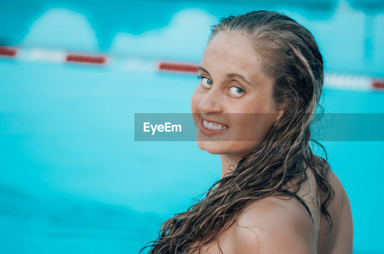 Portrait of smiling young woman in swimming in pool