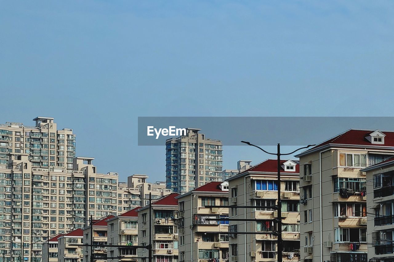 Low angle view of buildings against blue sky