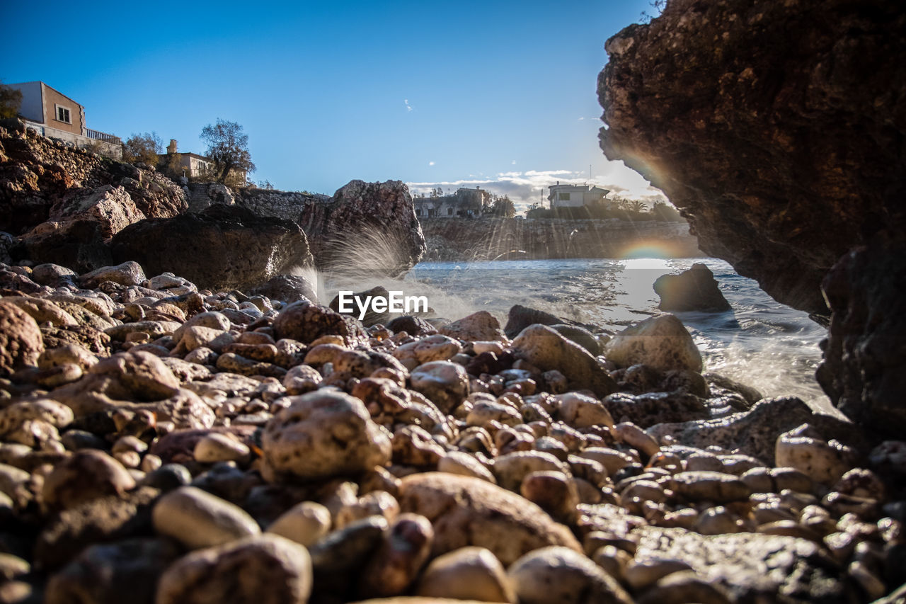 ROCKS ON SHORE AT BEACH