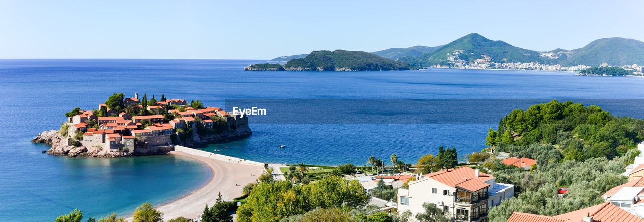 Panoramic view of sea and buildings against clear sky