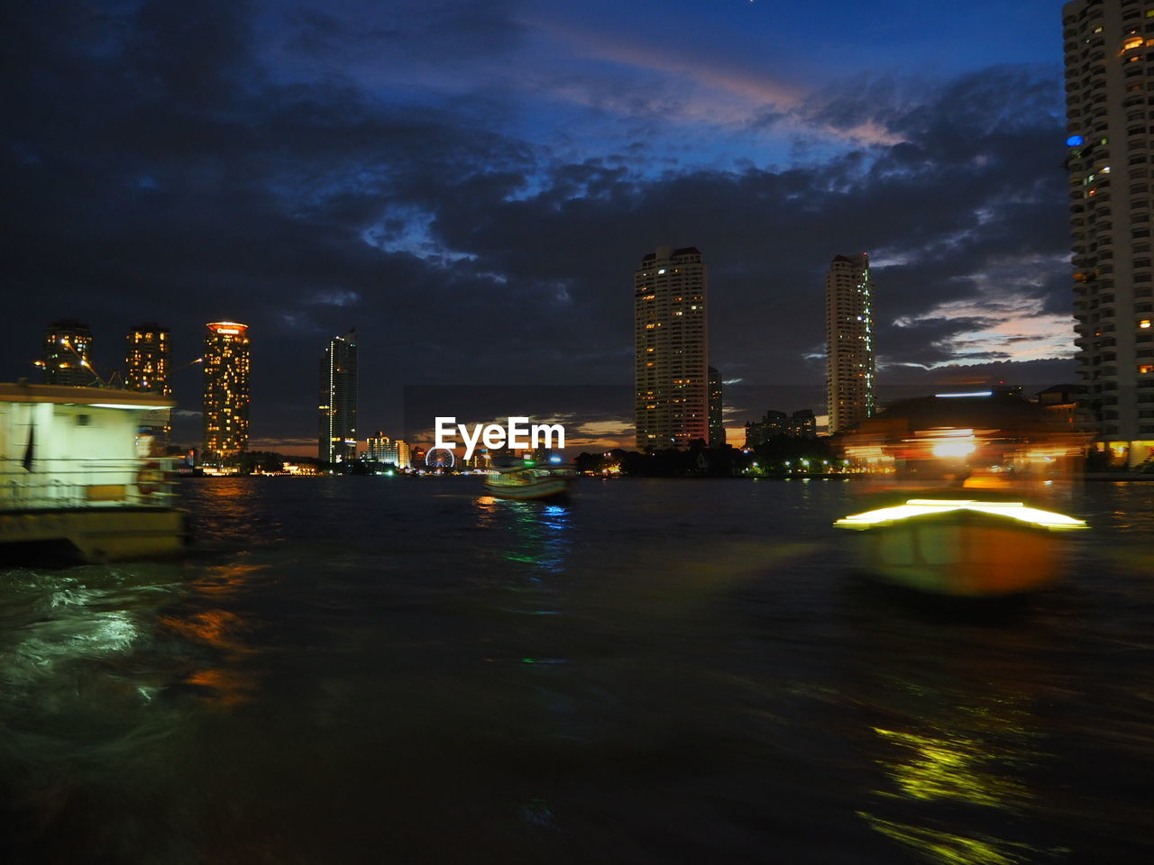 ILLUMINATED CITY AT WATERFRONT