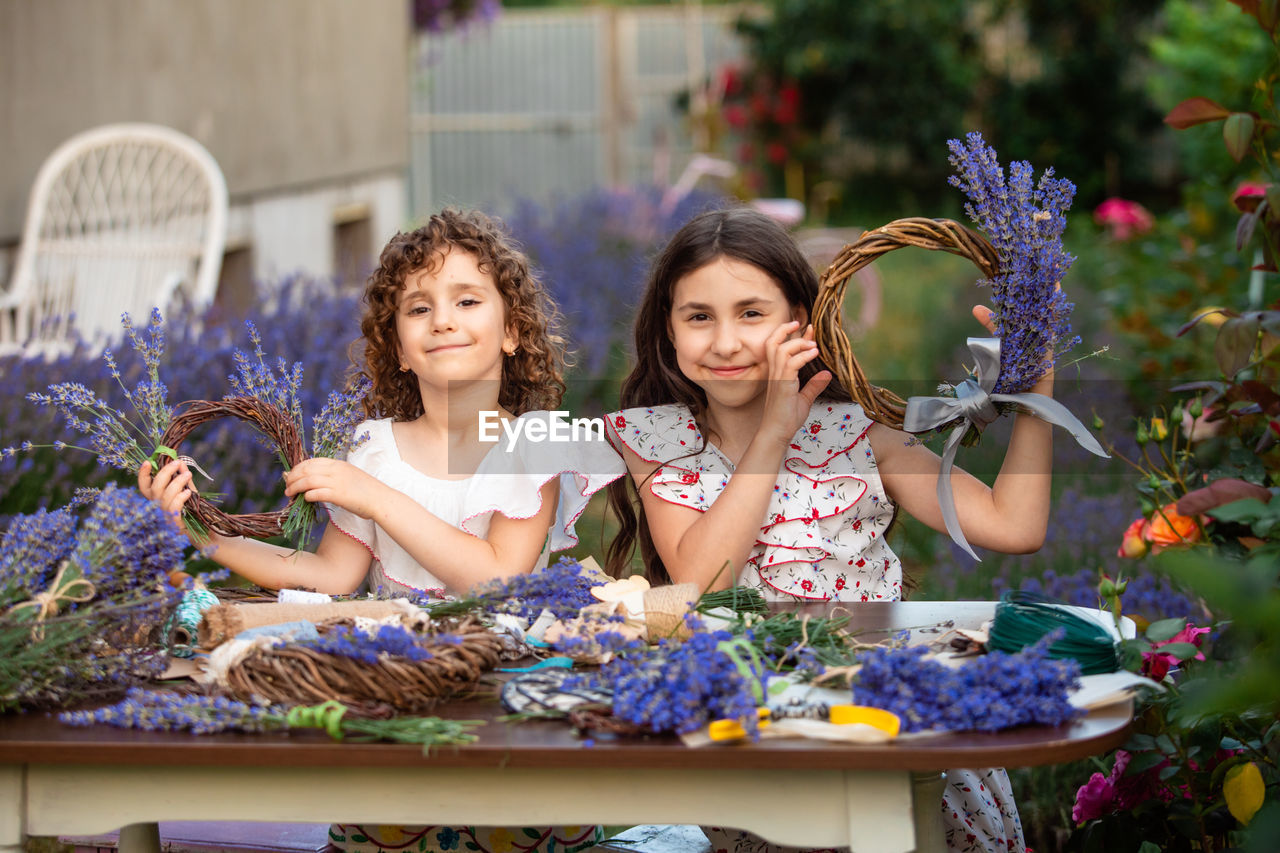 portrait of smiling friends sitting on table