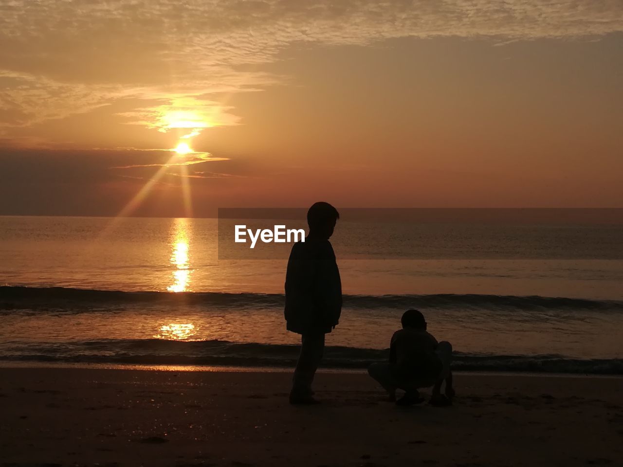 SILHOUETTE PEOPLE ON BEACH DURING SUNSET