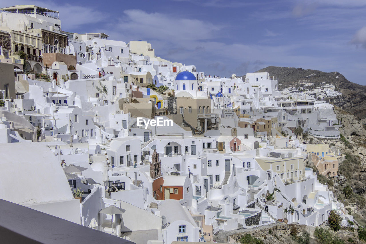 Santorini, greece, may 4, 2024. traditional village houses with blue dome