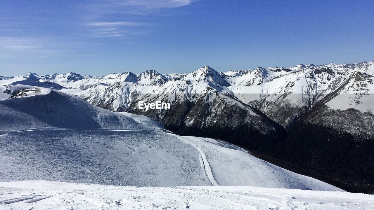 Snowcapped mountains against clear blue sky