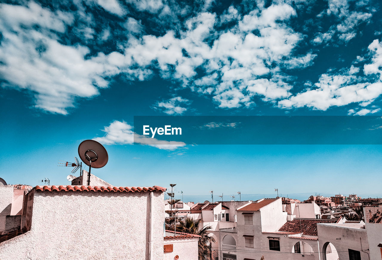 Low angle view of buildings against blue sky