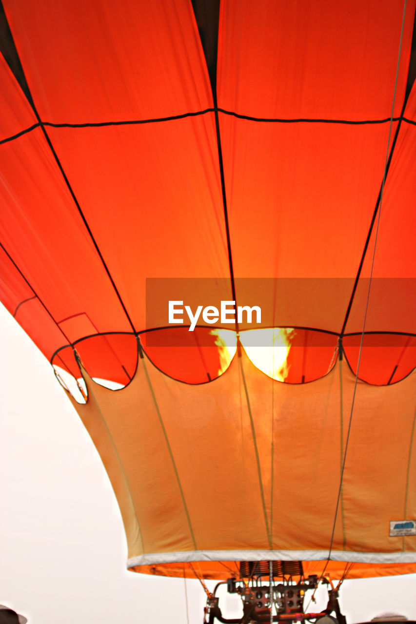 Low angle view of hot air balloon against orange sky