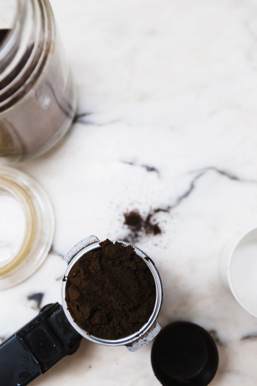 HIGH ANGLE VIEW OF COFFEE IN GLASS JAR ON TABLE