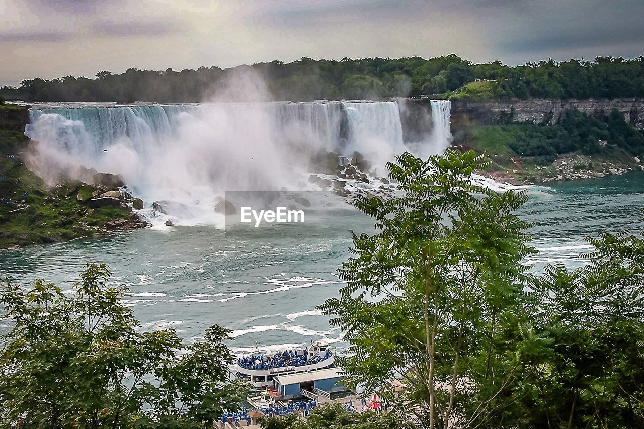 SCENIC VIEW OF WATERFALL AGAINST SEA