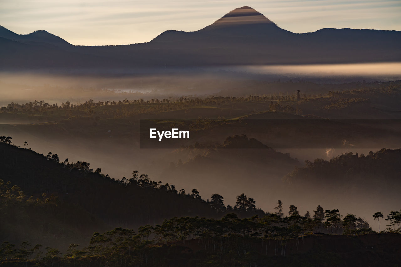 Scenic view of silhouette mountains against sky during sunset